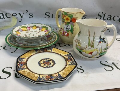 A collection of differently designed ceramics pottery and tableware. Some of the pieces are designed in the Art Deco tradition and some others consist of a more traditional Chinoiserie pattern. In the collection there is 3 plates, 1 bowl, 1 risen plate and two jugs with unique patterns