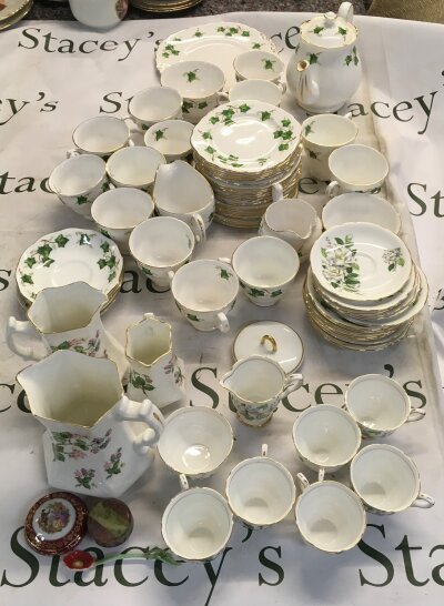 A collection of traditional British tea ware, featuring a classic trailing ivy leaf motif on a crisp white ceramic body
