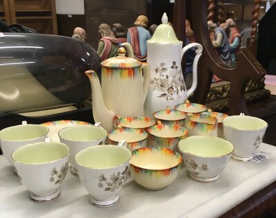 A classic piece of British Art Deco pottery, the items consist of a multi coloured splash effect around the rims using vivid colours and the interior of the cups feature a solid, pale glaze.