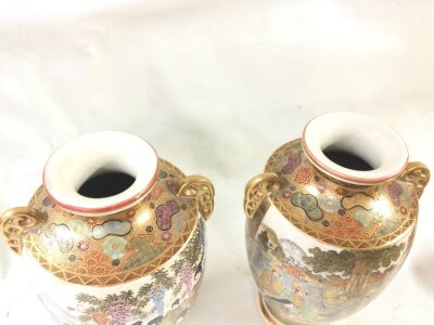 A pair of Japanese satsuma vases decorated with figures, 22cm tall