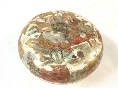 A satsuma jar with a cover and internal decoration. 13cm wide 7cm tall