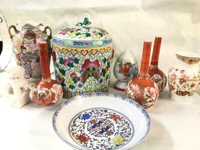 A collection of Chinese ceramics including a famille rose ginger jar with a lid, several long-necked bottle vases, and a charger or dish. NO RESERVE