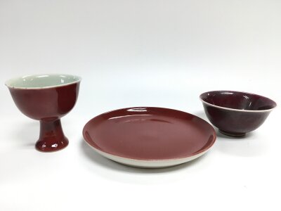 Chinese Sang De Boeuf red glaze items- dish (18cm wide), two cups (5 and 9cm tall)