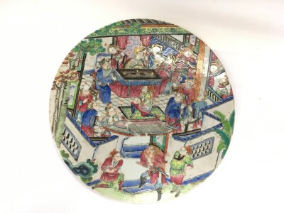 A 19th Century circular Canton wall plaque depicting a scene at court, approx diameter 28cm.