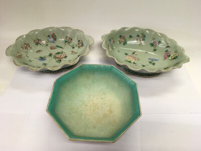 Three Chinese dishes comprising two oval shaped examples with scalloped rims and decorated with flowers and insects, approx width 28cm, plus one other octagonal example.