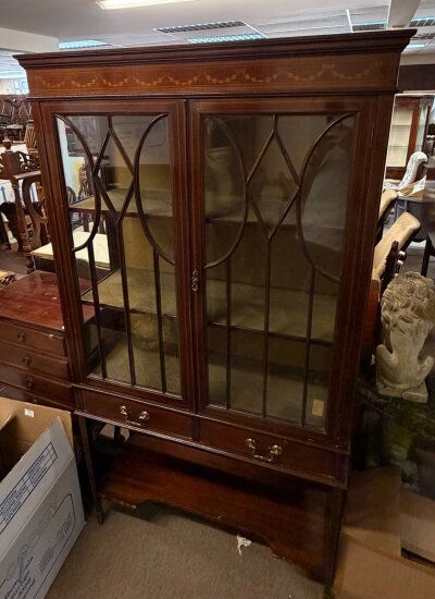 A glazed Edwardian display cabinet with inlaid decoration.