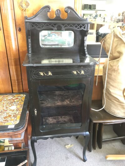 An Edwardian small display cabinet with raised mirrored back. 144cm tall , 56cm wide