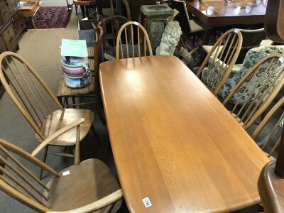 An Ercol dining table with chairs and a sideboard