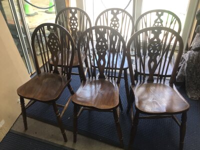 A set of six traditional Elm and Beechwood dining chairs wheel backs with solid seats on turned legs (6)