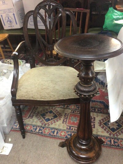 A quality Edwardian open arm chair with Prince of wales feather to the center of the open back above an upholstered seat on fluted legs and a late Victorian beechwood plant stand (2)