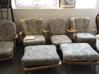 Four Ercol open arm chairs and two matching footstools