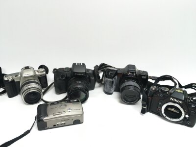 Four vintage SLR cameras Pentax, Nikons, Canons , Oynax. 1 point shoot camera