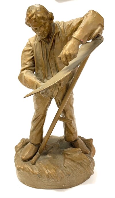 After Hans Muller, filled spelter figure of a harvest man sharpening his scyth, 37.5cm