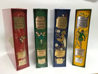 An assortment of The Folio Society books including the green, red, blue and yellow fairy books as well as a collection of six Winston churchill folio society books and a set of of beatrix potter books.