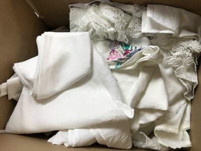 A collection of lace and linen , christening gowns