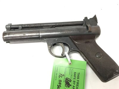 Vintage Webley Senior air pistol. It features a distinctive over-lever cocking mechanism and a blued steel finish with brown bakelite grips.