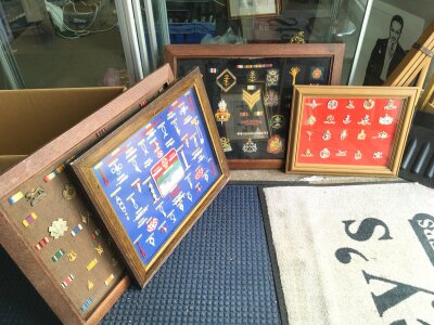 Four framed military displays containing various badges , one displaying knots. Largest dimensions 71x56cm