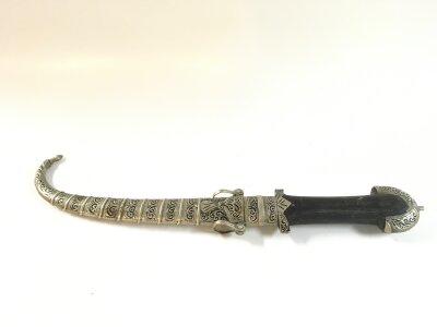 A North African Jambiya with white metal scabbard , wooden handle. Blade 21cm long ,40cm long total