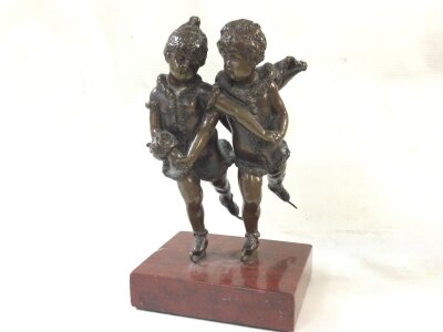 A small bronze early 20th century skating figure on a marble base. 17cm tall