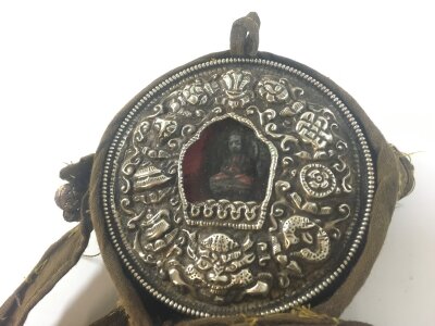 A vintage Tibetan travelling shrine with silver frontiers carrying case