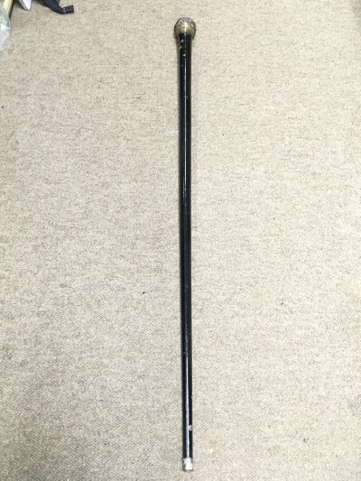 A walking stick with a silver hallmarked top. 94cm long