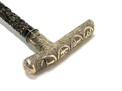 A fine 19th Century Chinese silver topped walking stick, with a carved ebony stick, engraved with Chinese characters, the silver top embossed with  bamboo design and Chinese characters. 88cm.