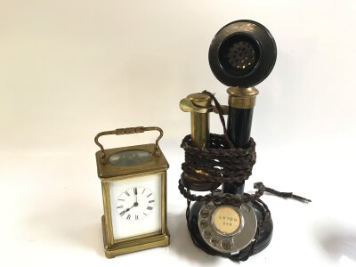 A vintage candlestick telephone and a carriage clock. 18 and 32cm tall