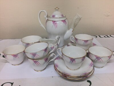 An early 20th century British bone china coffee set with pink and grey on a white ground chip to milk jug otherwise no obvious damage. NO RESERVE