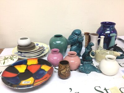 A Collection of Poole pottery including animal figures a lustre vase a colourful mid 20th century design dish and other Poole pottery.