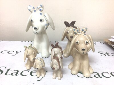 A Collection of Vintage Sylvac dog ornaments graduating in size impressed marks to the base maximum Hight 29cm ear damaged on large figure.