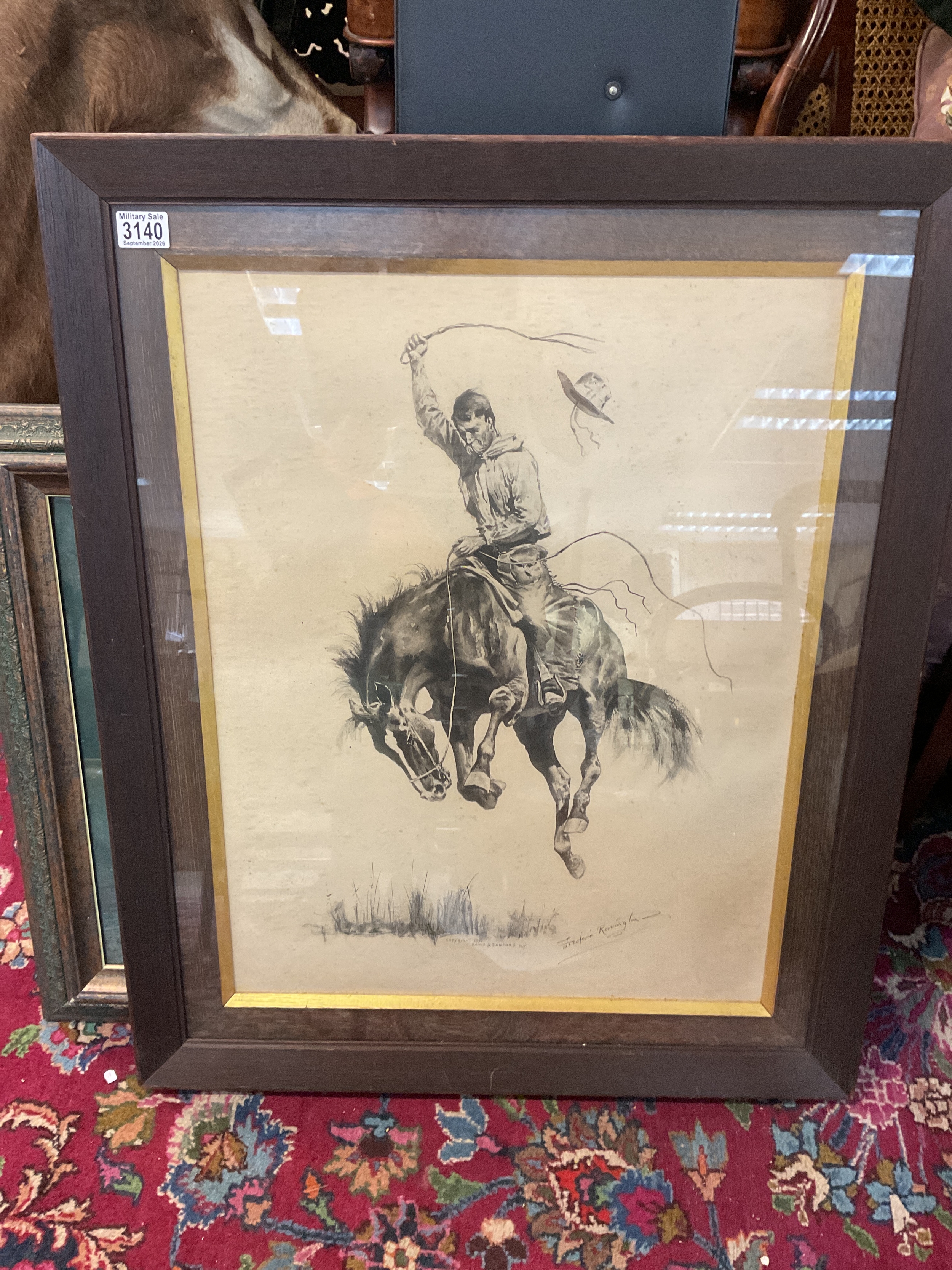 Framed and glazed F Remington picture of the Bronco Buster 