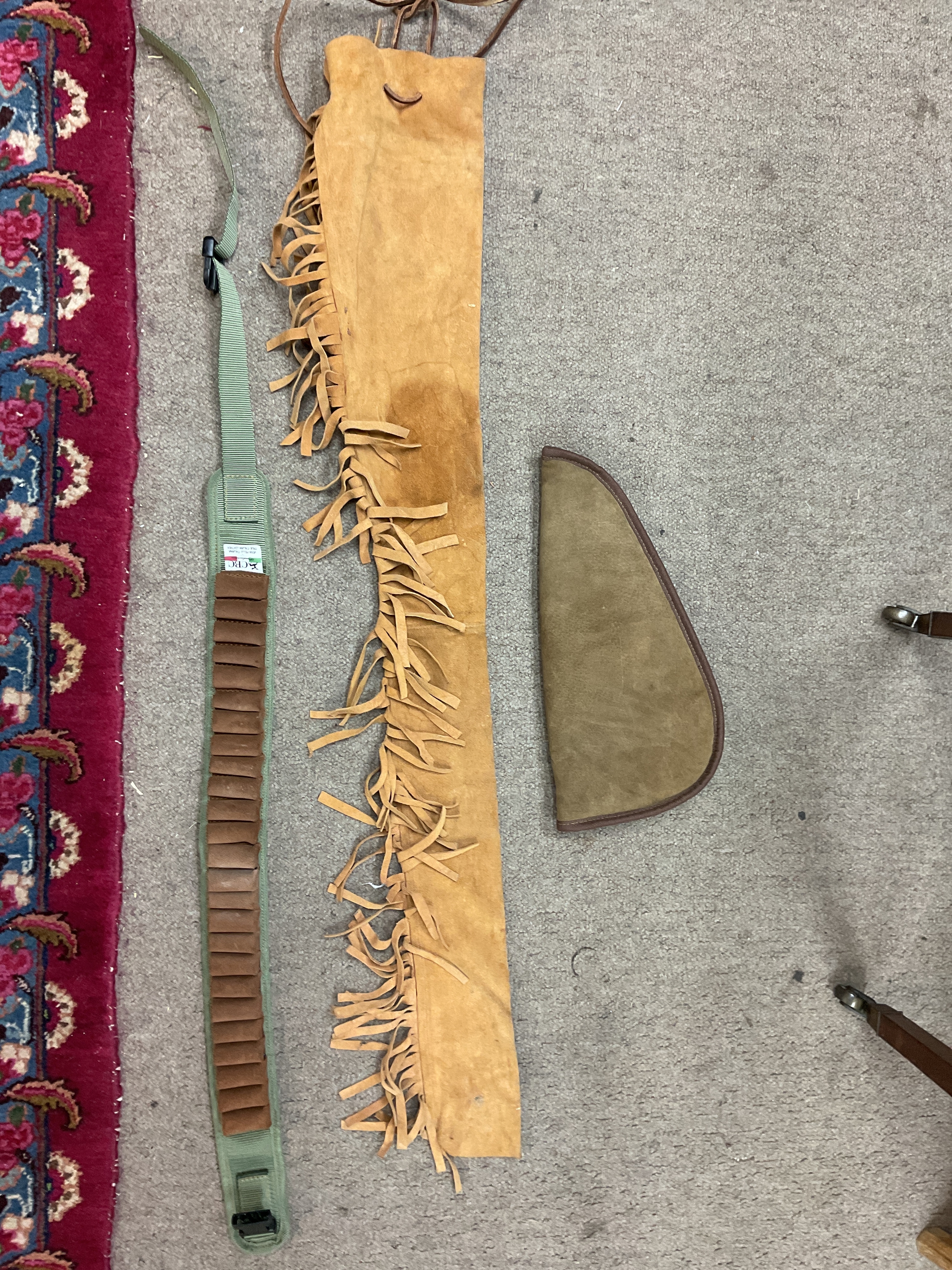 A calfskin rifle slip, pistol case and ammo belt 