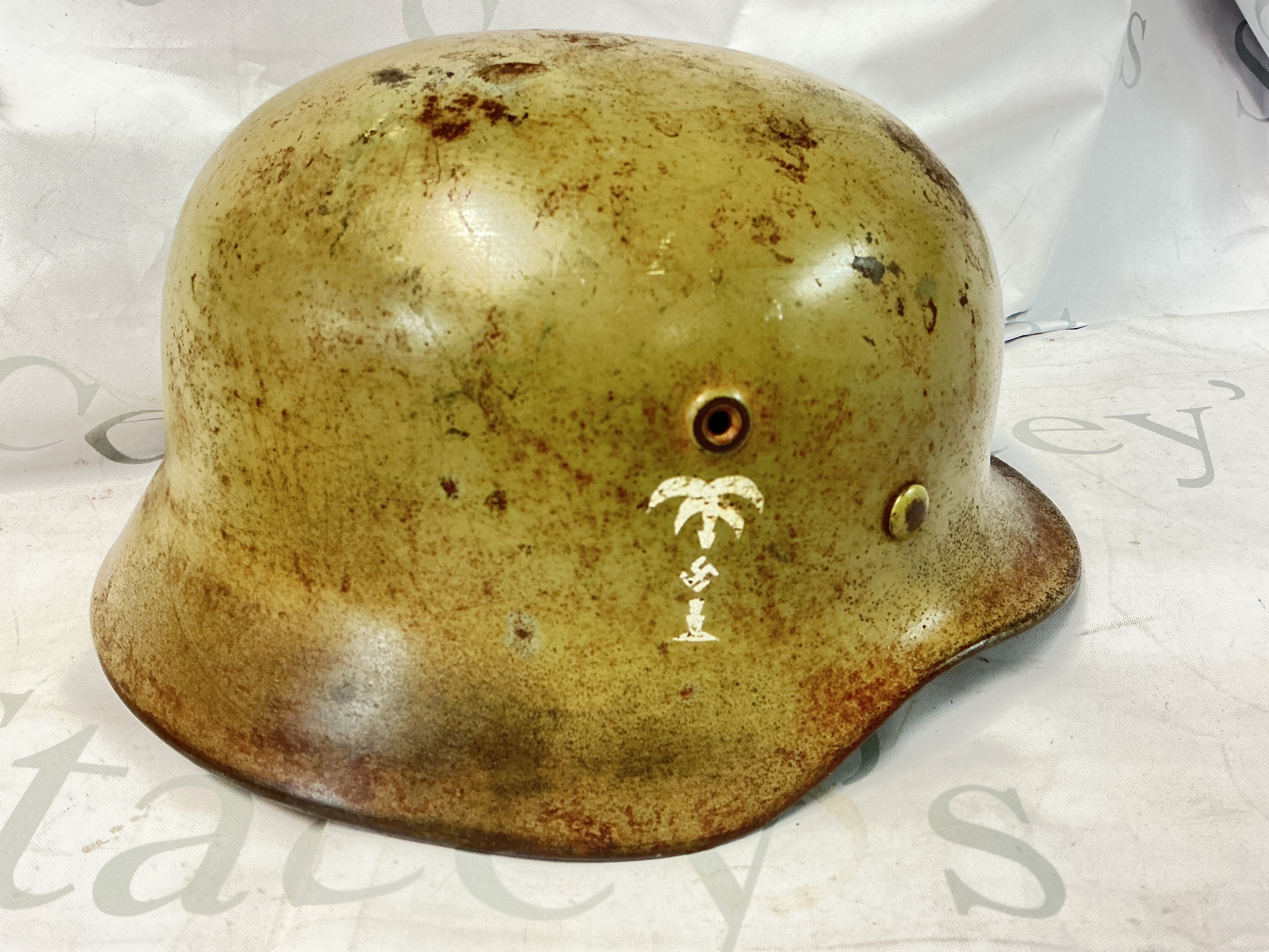 A WW2 German Luftwaffe Tropical M40 Helmet With With Palm Tree On One Side And Decal On Other Complete, Maker Quist Numbered, Chinstrap Also Numbered.