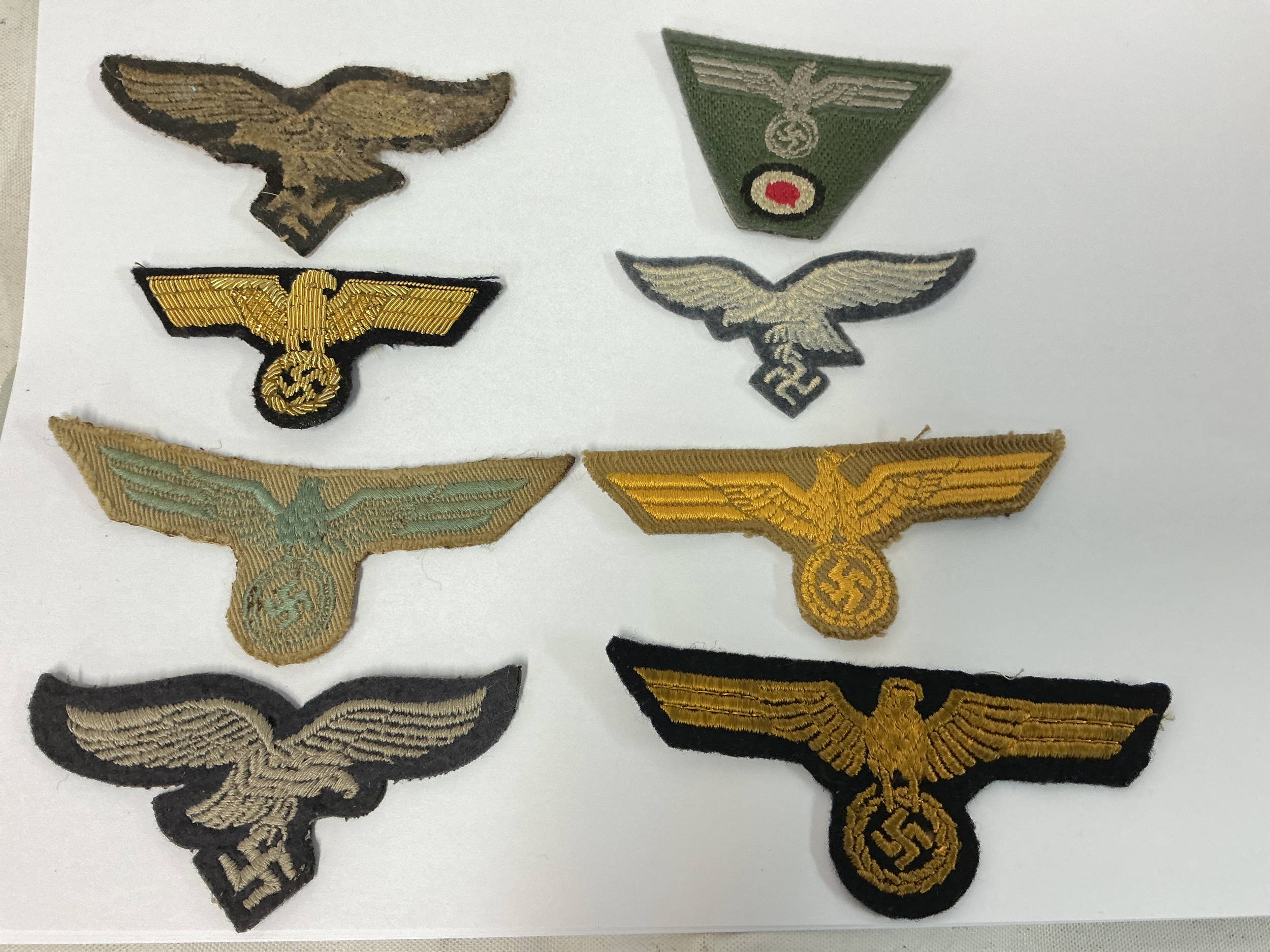 An Assortment Of Original WW2 German Brest Eagles, M43 Cap Eagle And A Kreigsmarine Cap Eagle.