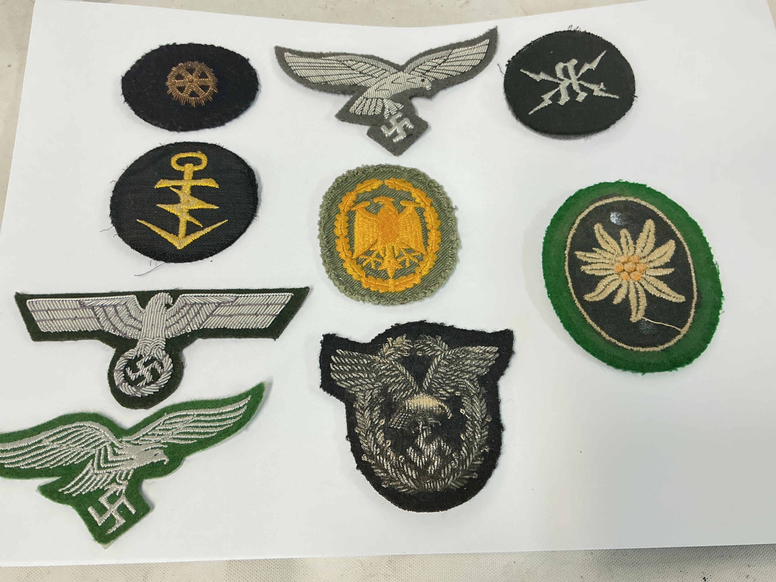 A Pilots Cloth Badge, Army Officers Brest Eagle, Luft Officers Brest Eagle, A Luft Forestry Breast Eagle, 3 Kreigsmarine Badges, A Mountain Troops Badge And A Eagle Badge.