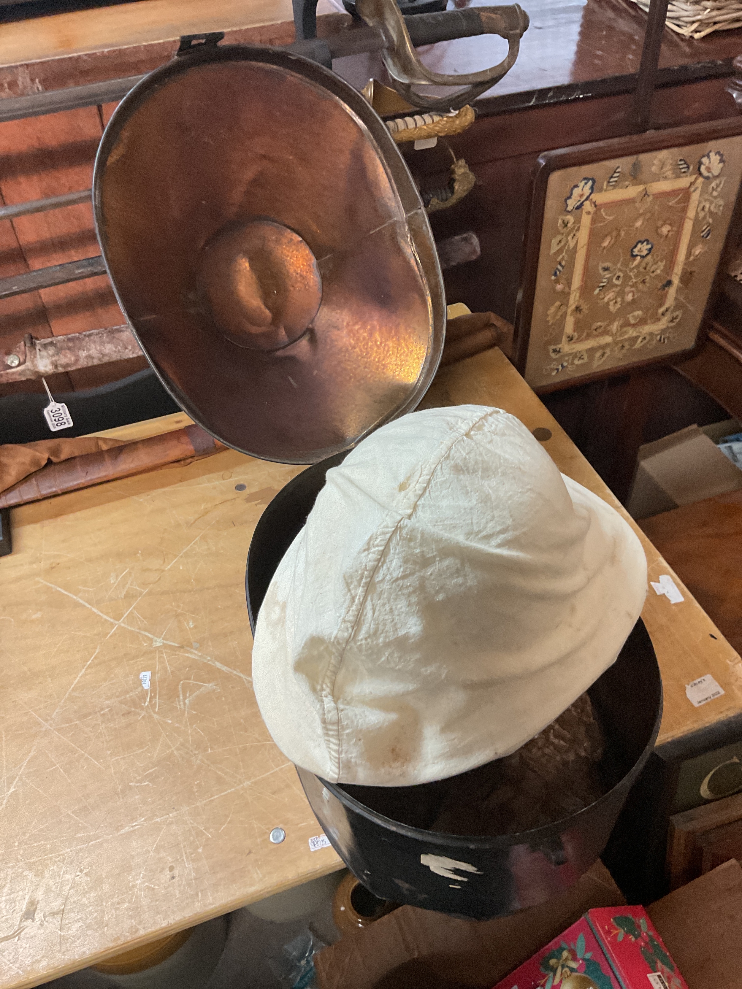 War era pith helmet in tin carry case with cover named to G Tomlinson RN.