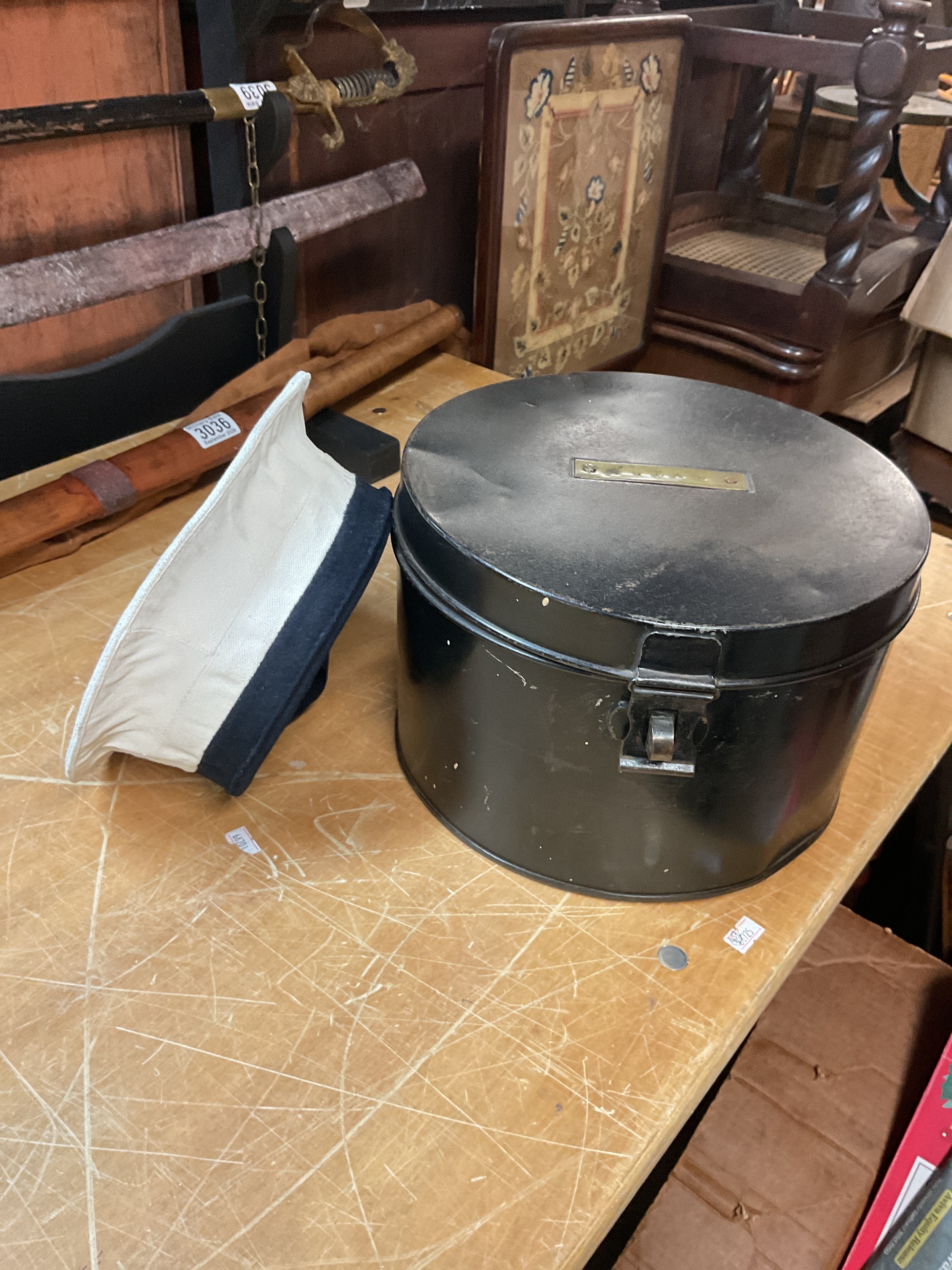Sailors cap in tin case.