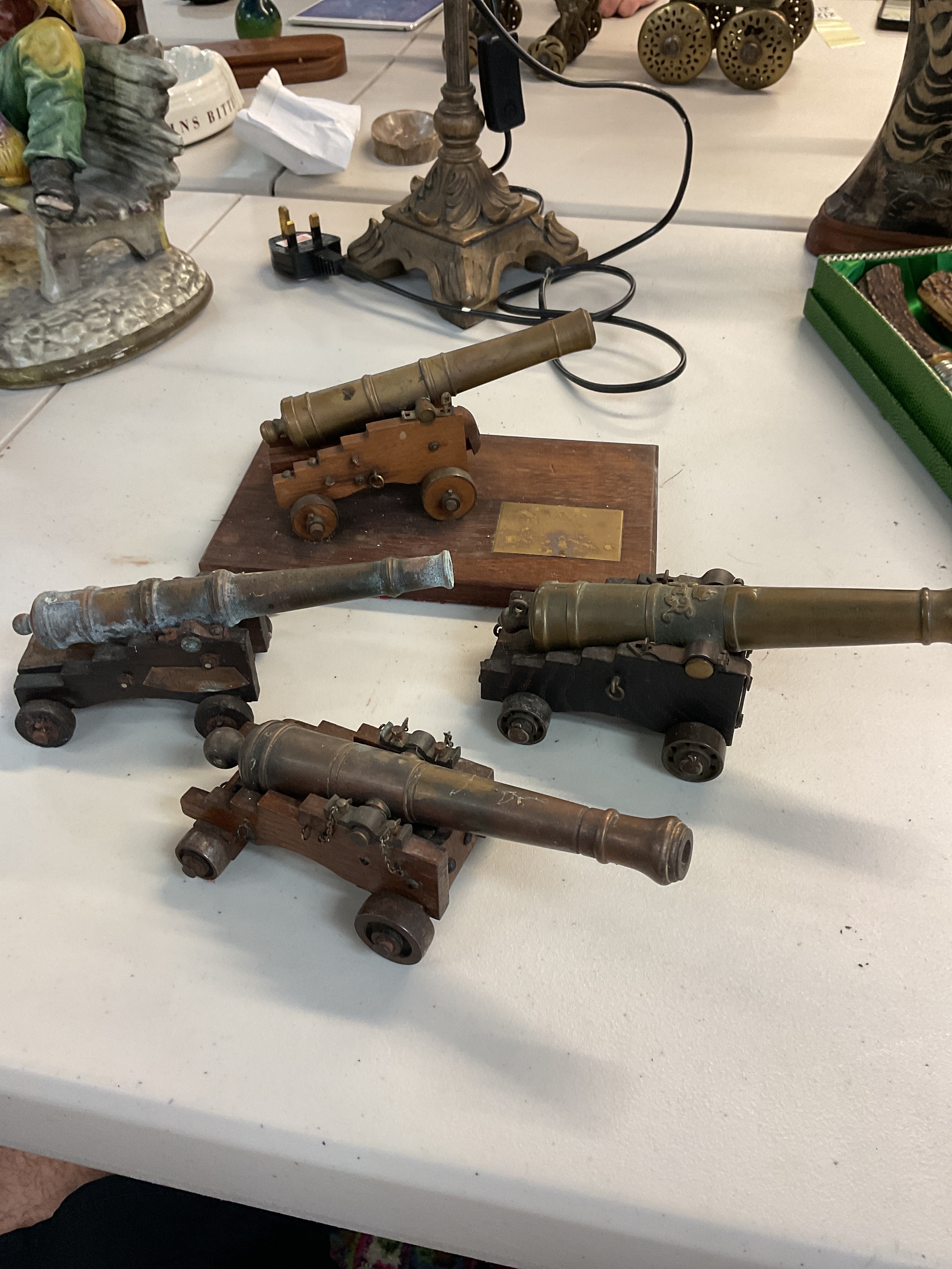 A collection of 4 miniature cannons. One being a model of a cannon used on the HMS Victory 