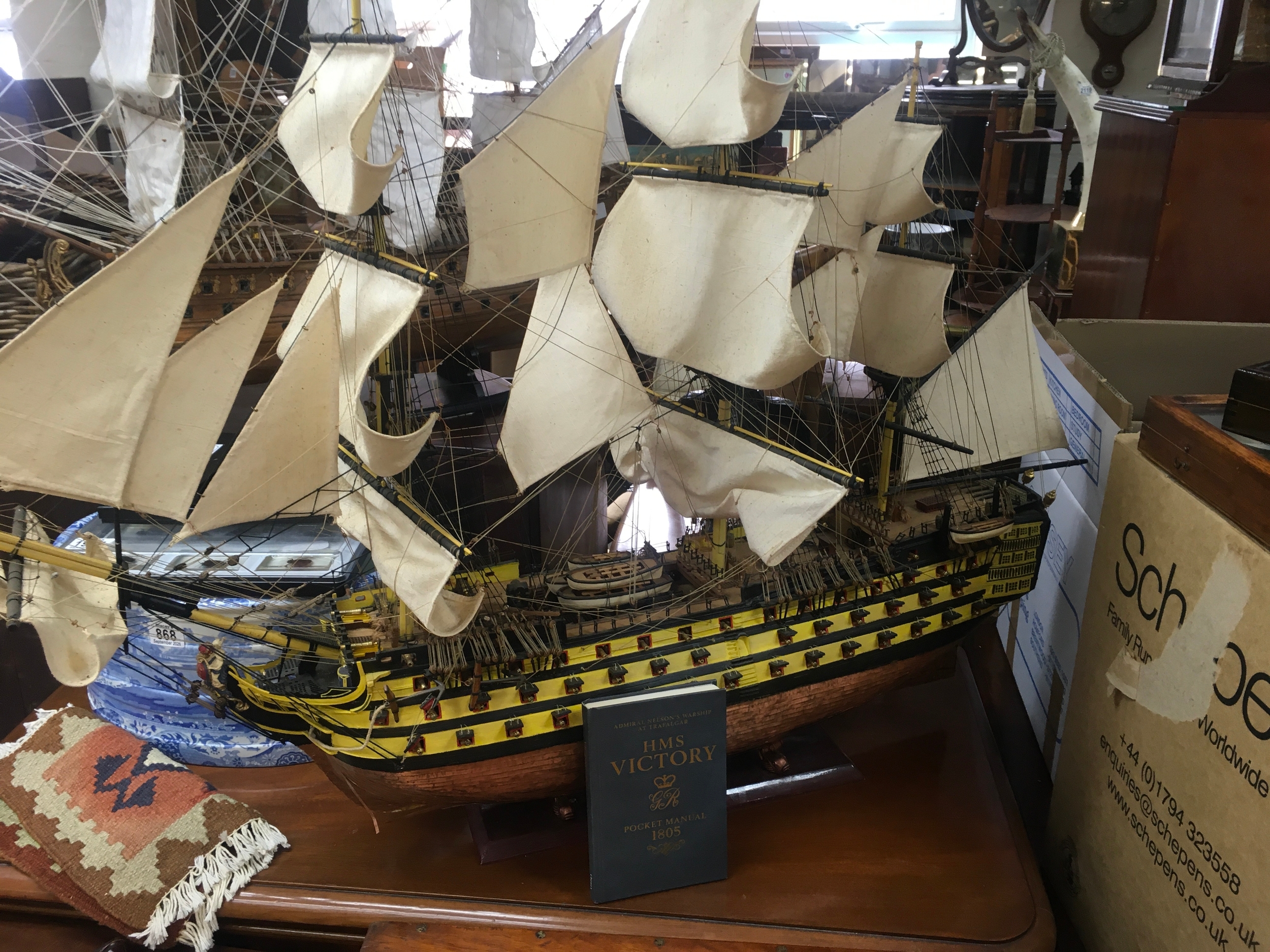 A model HMS Victory ship featuring a copper keel with book. 