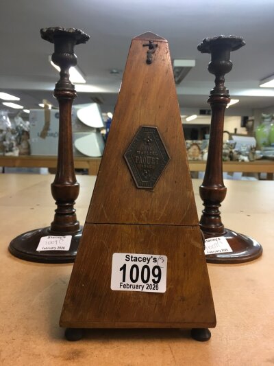 Two Edwardian candlesticks with metal sconces and mahogany cased metronome