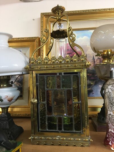 A brass hanging stained glass hall lantern. . Lantern dimensions 22cm wide, 60cm tall 21cm long