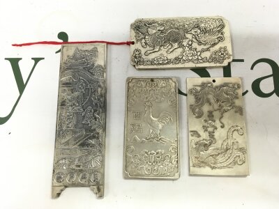 Four Chinese silver style ingots signed, largest 14cm long, total weight 643 grams
