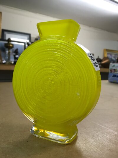 An Art Deco style yellow moulded glass vase in the shape of a sweet. 14cm in height
