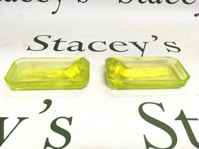 A pair of Art Deco uranium glass dishes of rectangular form decorated with nude maidens, approx length 11cm.