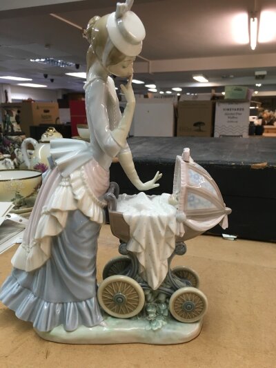 A Lladro figure mother and child .