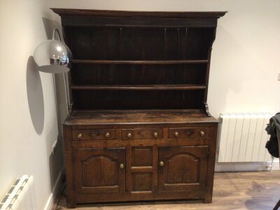 A good example of a mid 18th Century oak Welsh vernacular dresser with a raised back with open shelf’s above three drawers with panelled cupboards 142cm wide 179cm high