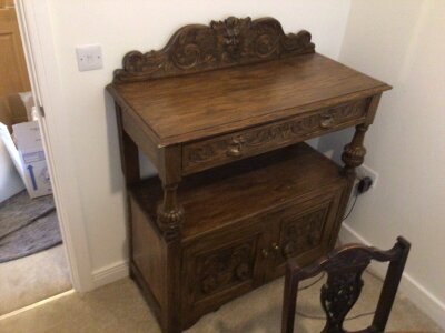 A late Victorian carved oak buffet with a drawer above turned columns with further cupboards  width 107cm