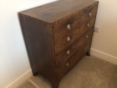 A late George III Mahogany chest of drawers fitted with two short and three long drawers on swept bracket feet. Length 90cm height 91cm