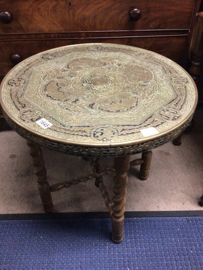 A brass top occasional table with a circular top on barely twist supports.