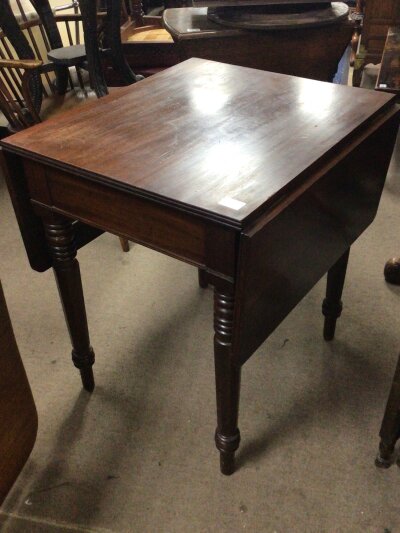 A Victorian mahogany drop leaf occasional table the twin flap top on turned legs